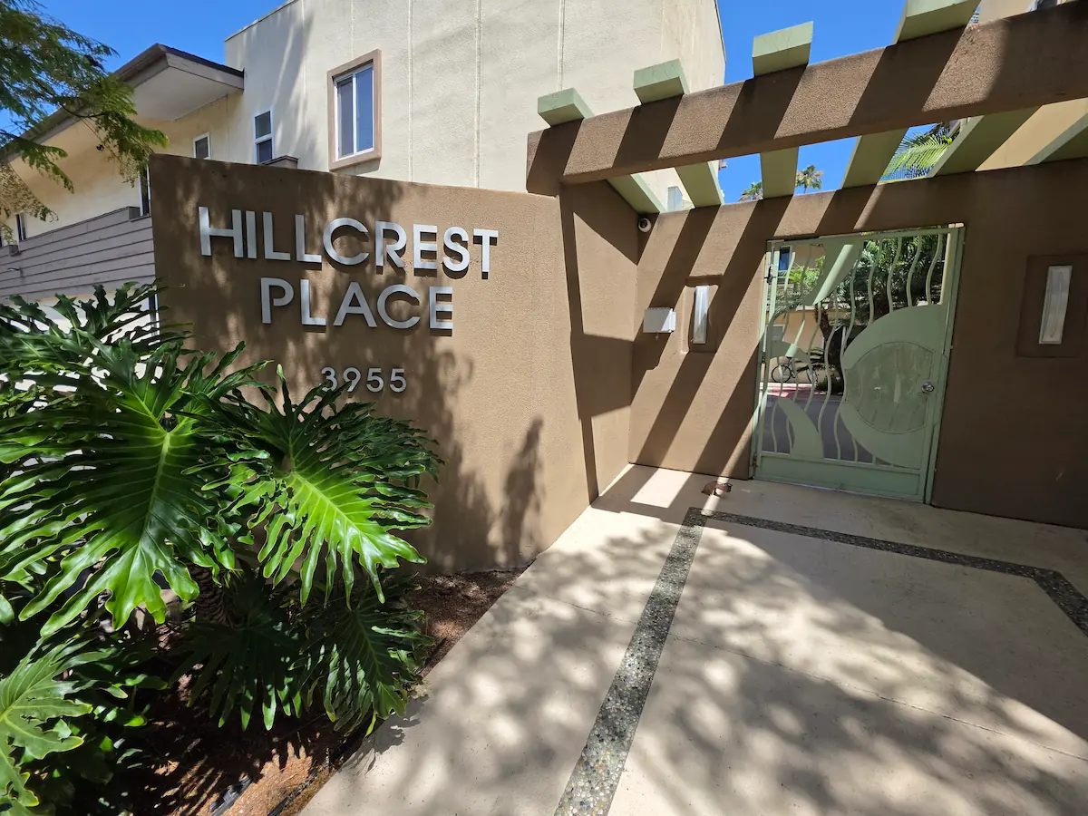 Gated main entrance to Hillcrest Place with tropical landscaping