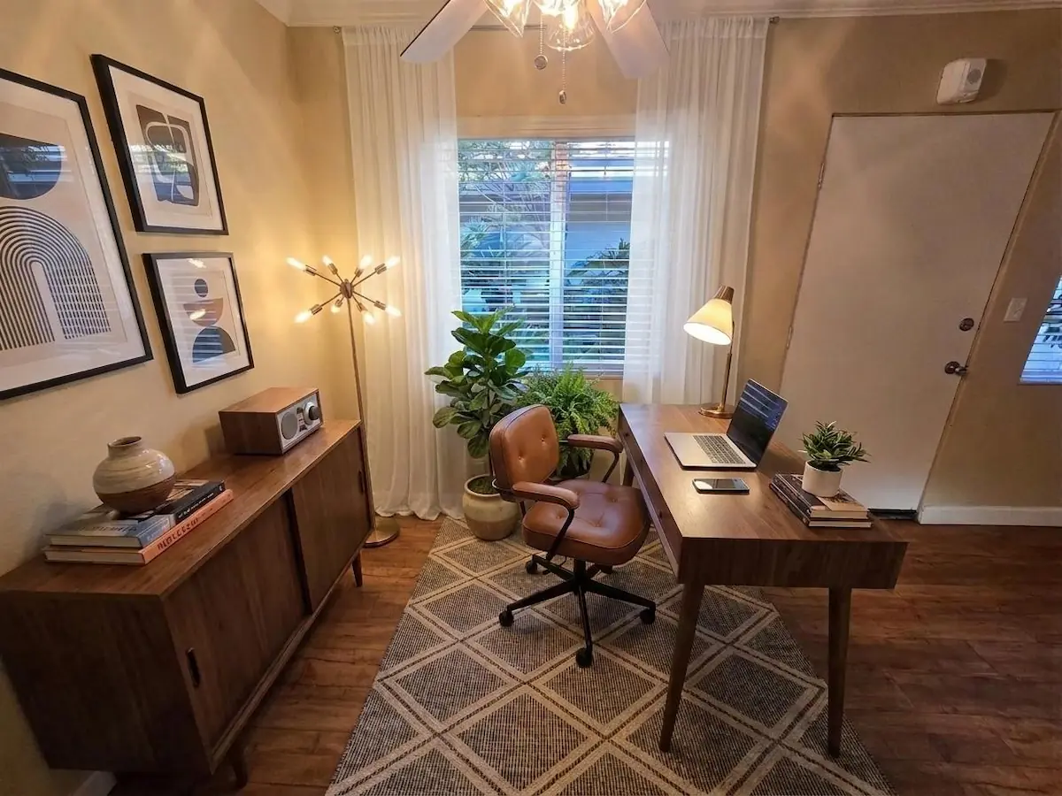 One-bedroom apartment with desk and monitor setup&mdash;virtually staged