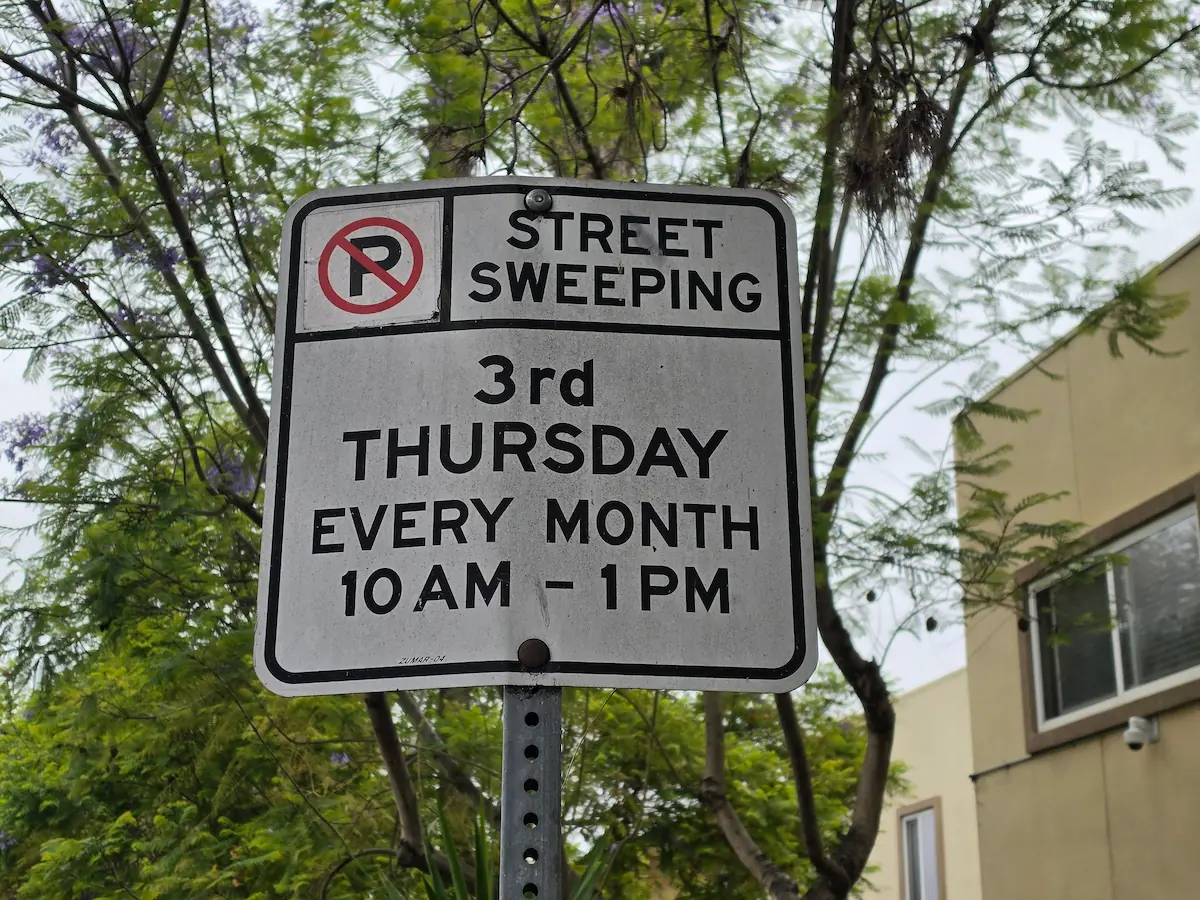 No-parking street sweeping signage on 7th Ave near Hillcrest Place